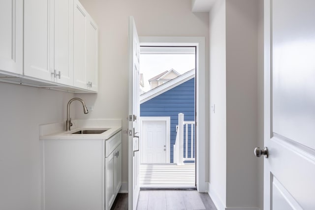 laundry area with sink and light wood-type flooring