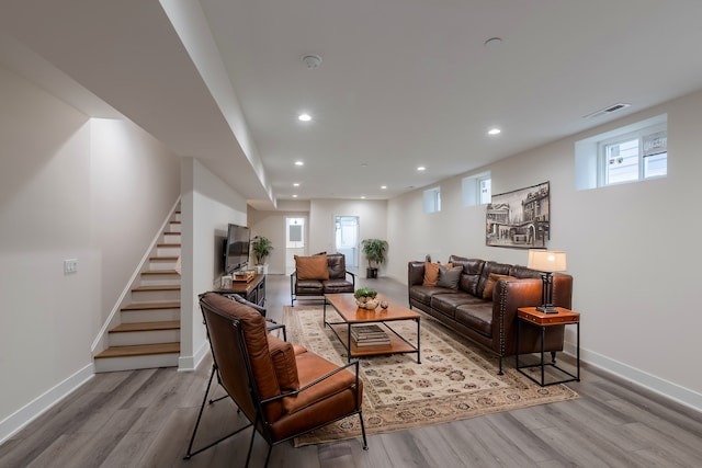 living room with light hardwood / wood-style floors and a wealth of natural light