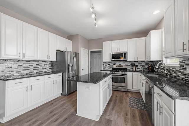 kitchen featuring appliances with stainless steel finishes, a kitchen island, and white cabinets