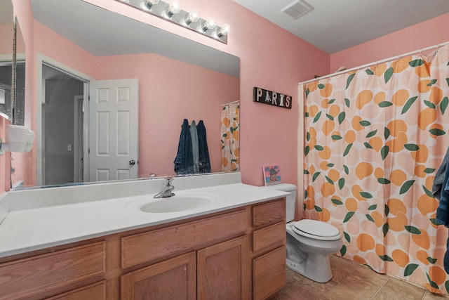 bathroom featuring vanity, curtained shower, tile patterned floors, and toilet