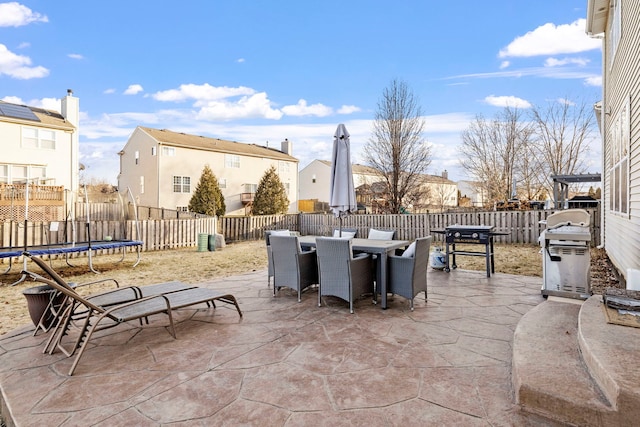 view of patio featuring area for grilling and a trampoline