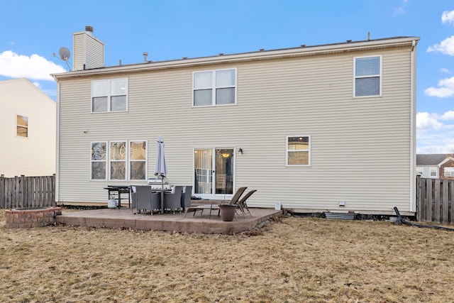 back of property with a yard and a patio area