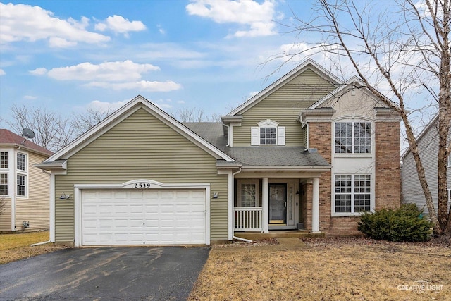 traditional-style house with aphalt driveway, a garage, brick siding, and a shingled roof