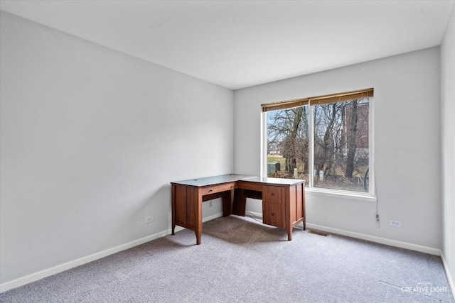 unfurnished office with light colored carpet, visible vents, and baseboards