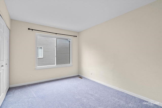 empty room with baseboards and carpet floors