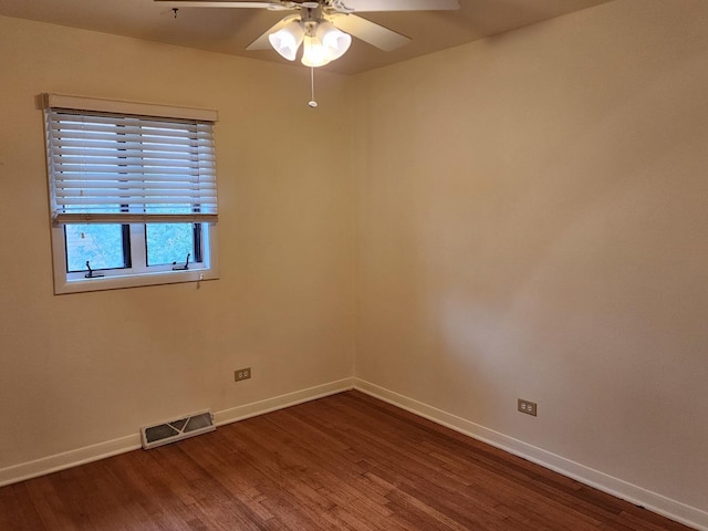 empty room with dark wood-type flooring and ceiling fan