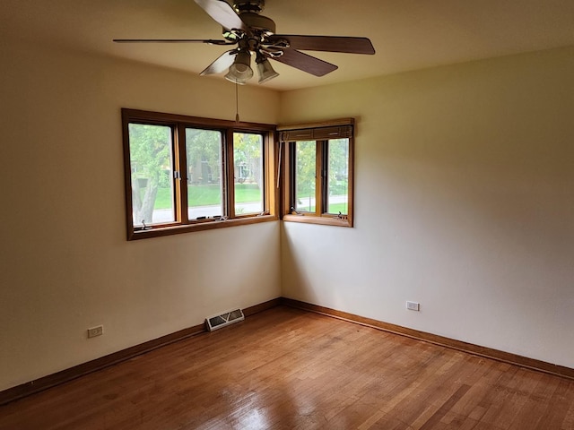 empty room featuring hardwood / wood-style floors and ceiling fan