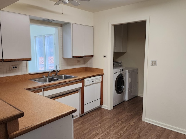 kitchen with sink, dark wood-type flooring, dishwasher, washing machine and clothes dryer, and white cabinets