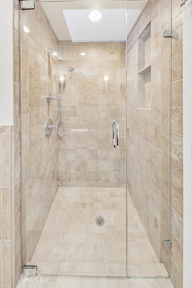 bathroom with a shower with shower door