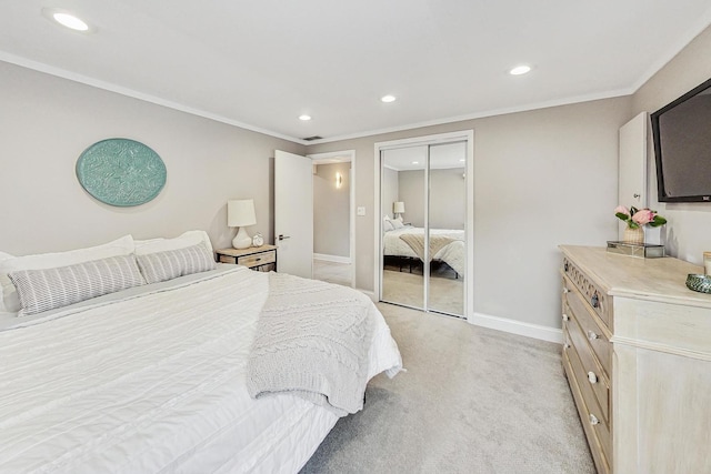 carpeted bedroom with ornamental molding and a closet