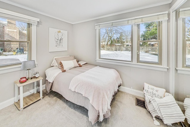 carpeted bedroom featuring crown molding