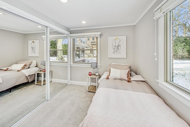 carpeted bedroom featuring multiple windows and ornamental molding