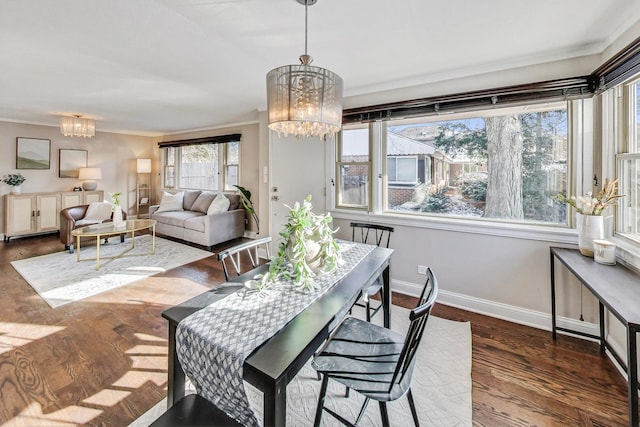 dining space featuring an inviting chandelier and dark wood-type flooring