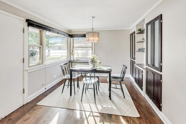 dining space with dark wood-type flooring and a chandelier