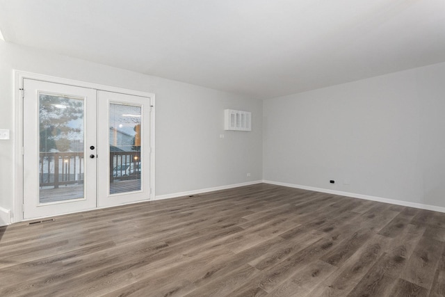 empty room with french doors and dark wood-type flooring