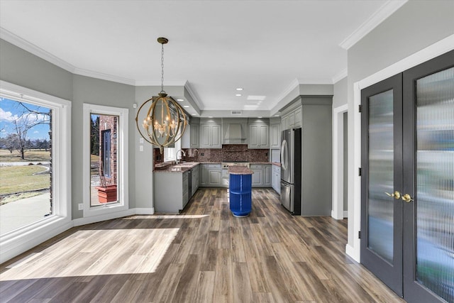1801 Cobblefield Ct, Champaign, IL 61822 - kitchen featuring stainless steel appliances, custom range hood, gray cabinets, a chandelier, and french doors