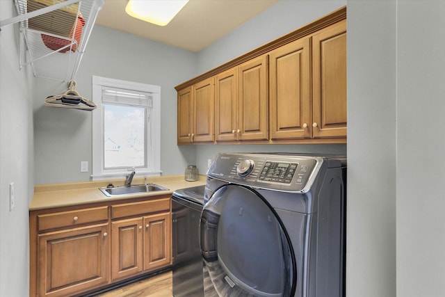 1801 Cobblefield Ct, Champaign, IL 61822 - laundry room featuring washer and clothes dryer, cabinet space, and light wood-style floors
