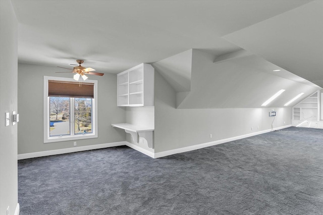 1801 Cobblefield Ct, Champaign, IL 61822 - additional living space with dark carpet, a ceiling fan, baseboards, and vaulted ceiling