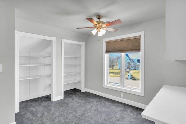 1801 Cobblefield Ct, Champaign, IL 61822 - unfurnished bedroom featuring dark carpet, ceiling fan, baseboards, and two closets