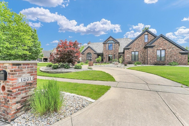 1801 Cobblefield Ct, Champaign, IL 61822 - view of front of property with brick siding, a front lawn, and curved driveway