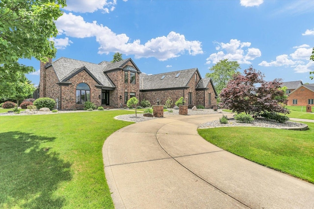 1801 Cobblefield Ct, Champaign, IL 61822 - tudor house featuring brick siding and a front lawn