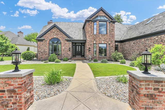 1801 Cobblefield Ct, Champaign, IL 61822 - view of front of property with brick siding, a front lawn, and a chimney