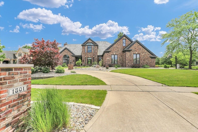 1801 Cobblefield Ct, Champaign, IL 61822 - view of front of house featuring brick siding, a front lawn, and a chimney