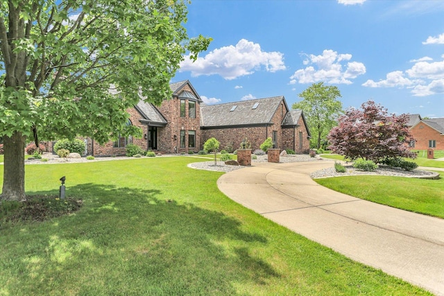 1801 Cobblefield Ct, Champaign, IL 61822 - tudor house with a front lawn, brick siding, and stone siding