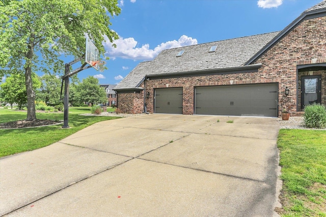 1801 Cobblefield Ct, Champaign, IL 61822 - view of side of home featuring brick siding, an attached garage, driveway, and a yard