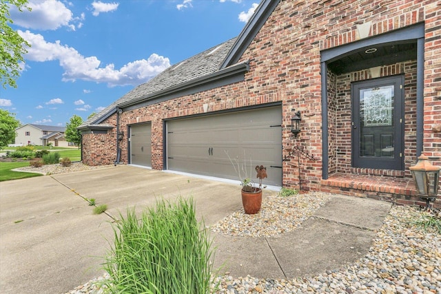 1801 Cobblefield Ct, Champaign, IL 61822 - view of side of property featuring brick siding, a garage, and driveway