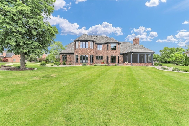 1801 Cobblefield Ct, Champaign, IL 61822 - back of property featuring a chimney, a sunroom, a yard, and brick siding
