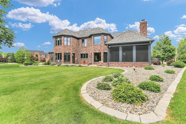 1801 Cobblefield Ct, Champaign, IL 61822 - back of property featuring a chimney, a sunroom, brick siding, and a yard