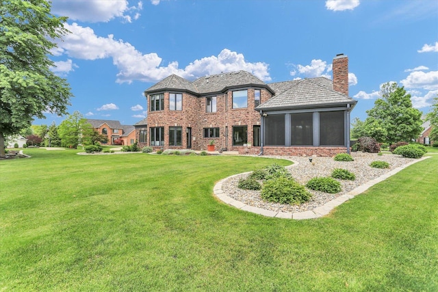 1801 Cobblefield Ct, Champaign, IL 61822 - rear view of property with a sunroom, a chimney, and a yard