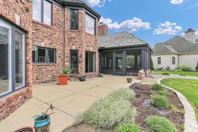 1801 Cobblefield Ct, Champaign, IL 61822 - back of property with a sunroom, brick siding, and a patio area