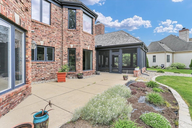 1801 Cobblefield Ct, Champaign, IL 61822 - rear view of property with a sunroom, a patio area, brick siding, and a yard