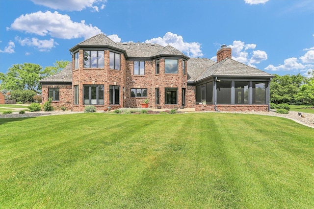 1801 Cobblefield Ct, Champaign, IL 61822 - back of property with a chimney, a sunroom, a yard, and brick siding