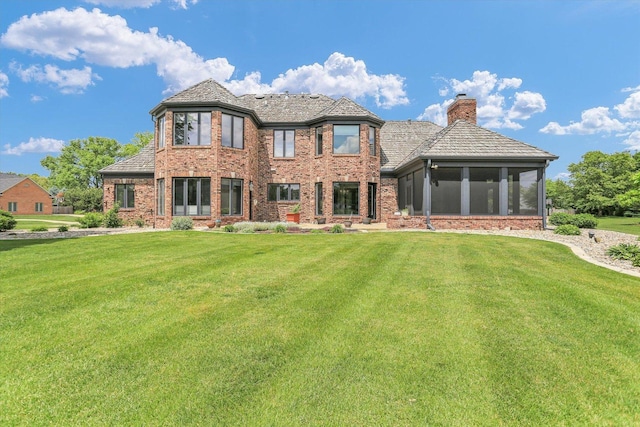 1801 Cobblefield Ct, Champaign, IL 61822 - view of front of property with a chimney, a sunroom, brick siding, and a front lawn