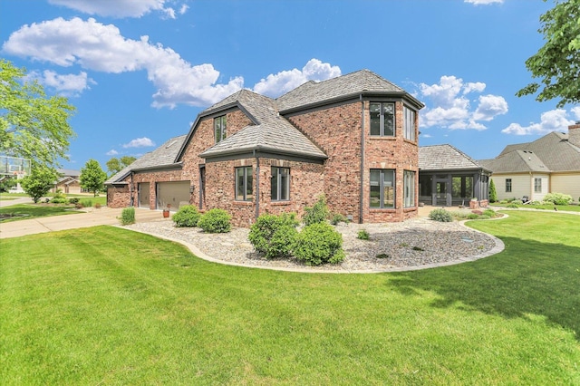1801 Cobblefield Ct, Champaign, IL 61822 - view of property exterior with brick siding, a lawn, driveway, an attached garage, and a sunroom