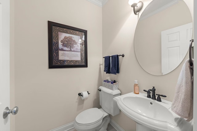 bathroom with crown molding, sink, and toilet