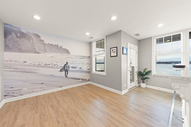 interior space featuring a water view and light hardwood / wood-style flooring