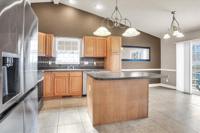 kitchen with light tile patterned floors, appliances with stainless steel finishes, and vaulted ceiling