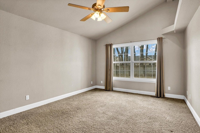 carpeted spare room featuring lofted ceiling, a ceiling fan, and baseboards