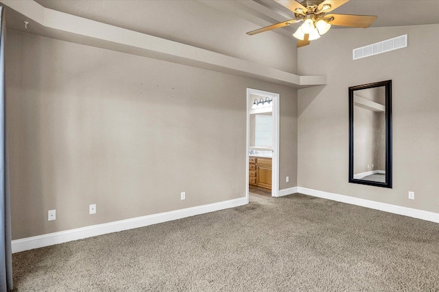 unfurnished bedroom featuring carpet, ensuite bath, visible vents, and baseboards