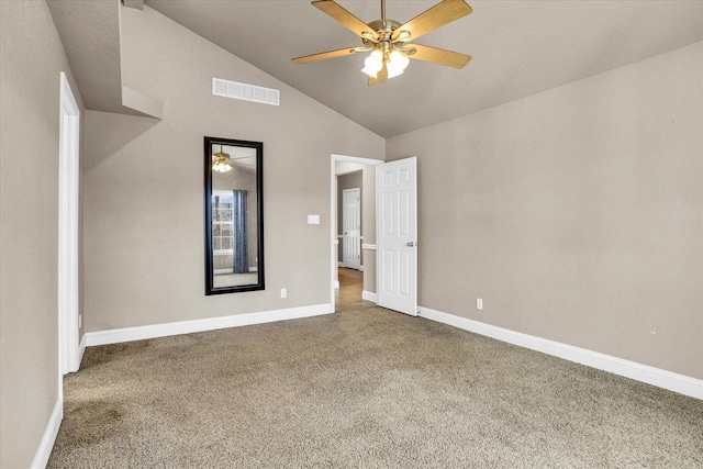 carpeted spare room featuring lofted ceiling, ceiling fan, visible vents, and baseboards