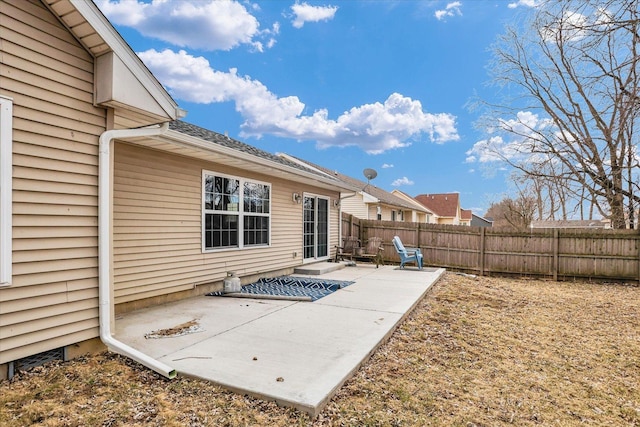 rear view of house featuring fence private yard and a patio area