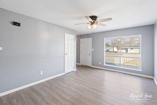 unfurnished room featuring light hardwood / wood-style flooring and ceiling fan