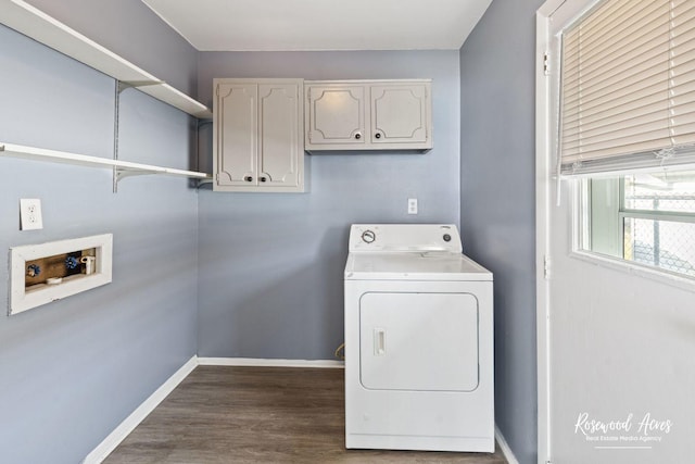 laundry area featuring cabinets, wood-type flooring, and washer / dryer