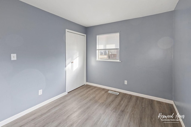 unfurnished room with light wood-type flooring