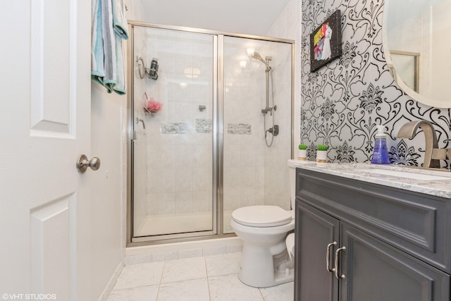 bathroom with an enclosed shower, vanity, and toilet