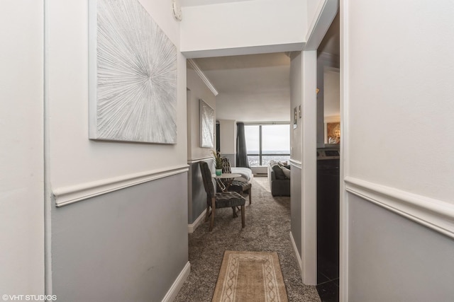 hallway featuring dark colored carpet